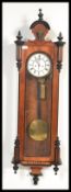 A vintage Vienna Regulator mahogany wall clock having turned columns and arched pediment. The