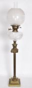 A 19th century Victorian tall oil lamp raised on a stepped square base with classical column cut