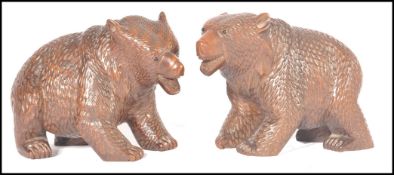 A pair of black forest bears being well carved wit