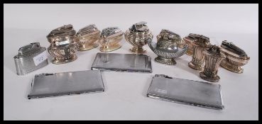 A collection of silver plated lighters to include mostly Ronson table lighters , along with three