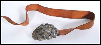A vintage early 20th century leather belt having a
