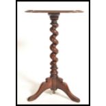 A 19th century Victorian mahogany wine side occasional table raised on tripod legs with barley twist