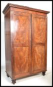 A 19th century George III mahogany double wardrobe