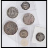 A collection of pre decimal silver coins dating from the early 19th century containing various