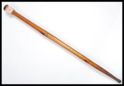 A vintage novelty walking stick cane having a pain