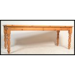 A large 20th century country pine refectory dining table having a fitted frieze with planked top