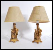 A pair of gilt cast resin classical table lamps wi
