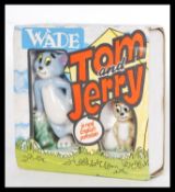 A vintage retro Wade porcelain Tom & Jerry figure set in original packaging. Highest measures 9 cm.