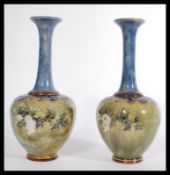 A pair of early 20th century Royal Doulton salt glazed stoneware baluster vases. The globular bodies