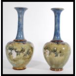 A pair of early 20th century Royal Doulton salt glazed stoneware baluster vases. The globular bodies