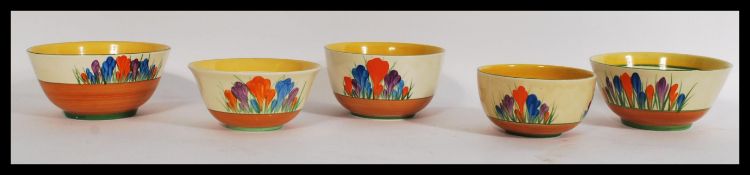 A group of five vintage 20th century Clarice Cliff bowls in the Crocus pattern. The bowls of varying