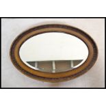 An early 20th century 1930's oval wall mirror havi