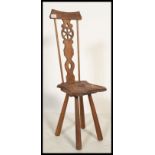 A 19th century Victorian arts and crafts carved oak spinning chair having a hand carved Lancaster