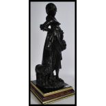 A large 20th century faux bronze statue of a girl