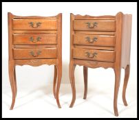 A pair of French walnut bedside chests of drawers