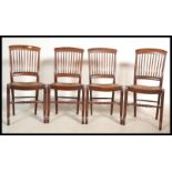 A group of four early 20th century Edwardian Industrial solid mahogany dining / boardroom chairs
