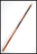A carved Japanese walking stick cane having a bone