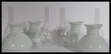 A set of four vintage oil lamp shades and flumes o