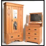 An Edwardian satin walnut bedroom suite consisting of a single wardrobe with plinth drawers and