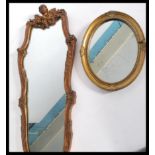 Two vintage mirrors one adorned with cherub masks and scrolled decoration and the other of simpler