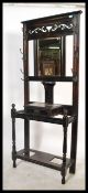 An Edwardian ebonised mahogany hallstand of uprigh