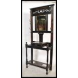 An Edwardian ebonised mahogany hallstand of uprigh