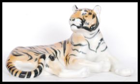 A large ceramic figure modelled as a tiger, marked USSR underneath in a reclined position.