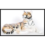 A large ceramic figure modelled as a tiger, marked USSR underneath in a reclined position.