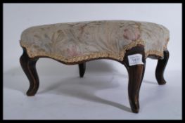 A  Victorian mahogany upholstered footstool of square form raised on sabrre reeded legs and