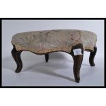 A  Victorian mahogany upholstered footstool of square form raised on sabrre reeded legs and