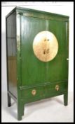 A Chinese Green Lacquer Marriage Cabinet.  The twin panelled doors with shelf set within along