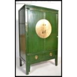 A Chinese Green Lacquer Marriage Cabinet.  The twin panelled doors with shelf set within along