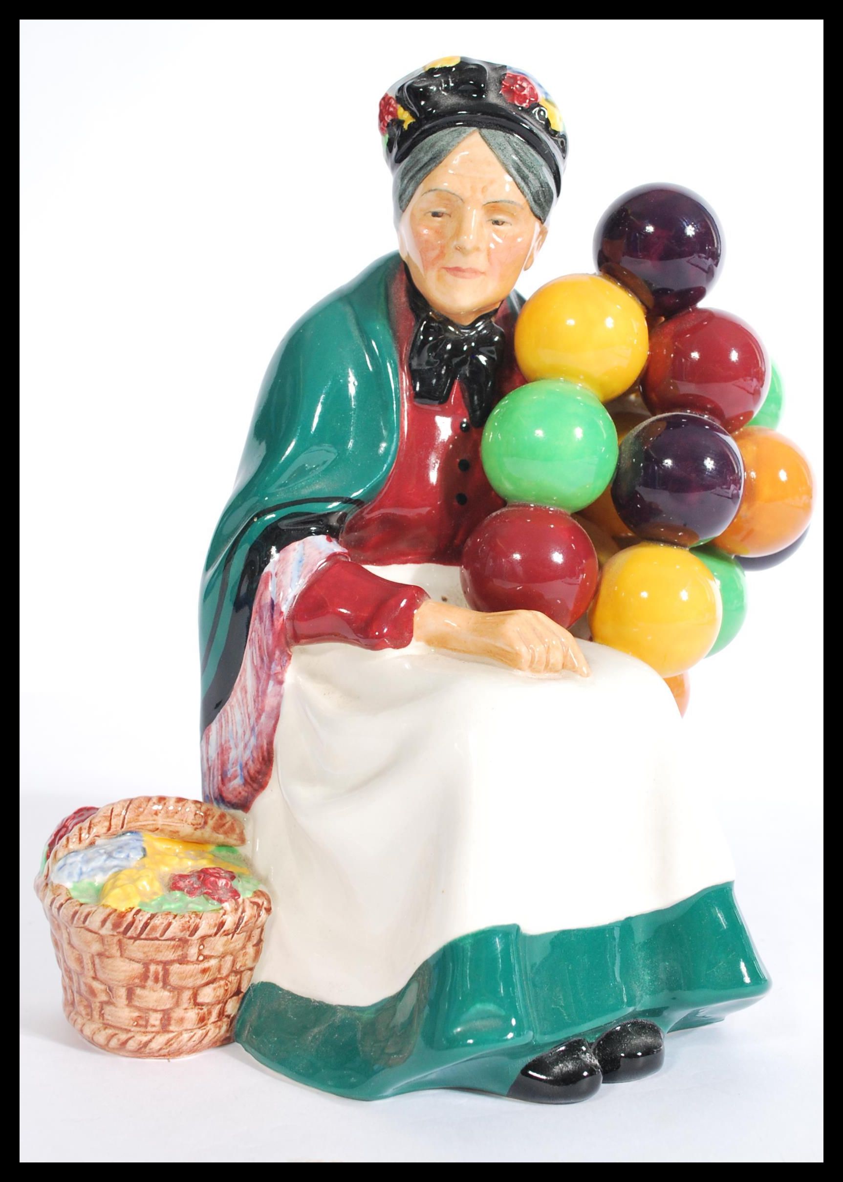 A vintage 20th century Royal Doulton ' The Old Balloon Seller ' HN1315 ceramic figurine, 20cm high