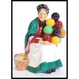 A vintage 20th century Royal Doulton ' The Old Balloon Seller ' HN1315 ceramic figurine, 20cm high