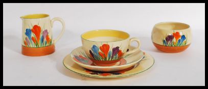 A vintage 20th century Clarice Cliff tea for one in the Crocus pattern consisting of a cup saucer