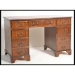 An antique Georgian style mahogany twin pedestal office desk having pedestals, each with banks of