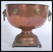 A 19th Century Victorian Arts and Crafts large copper hand worked pedestal rose bowl, twin lion mask