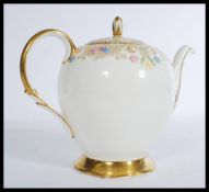 A 20th Century bone China teapot decorated with gi