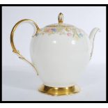 A 20th Century bone China teapot decorated with gi