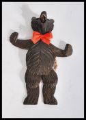 A 20th century carved blackforest articulated dancing bear with glass eyes having moving arm and