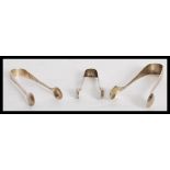 A group of three silver hallmarked sugar tongs nips dating from the 19th century to include a