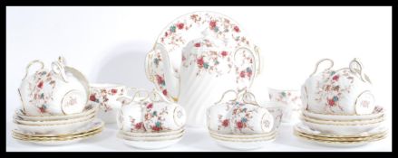 A vintage 20th Century floral bone China 35 piece tea service by Mintons in the Ancestral pattern to