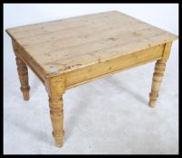 A VIctorian 19th century country pine dining table being raised on turned legs with fitted frieze,