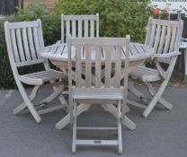 A set of 20th Century good quality heavy teak garden furniture comprising of a circular table and