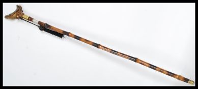 A vintage walking stick cane having a tapering tor