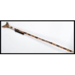 A vintage walking stick cane having a tapering tor