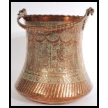 A Persian Safavid large copper bucket with large shaped  handle and deeply engraved foliate