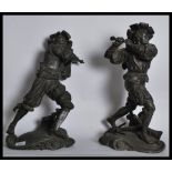 A pair of early 20th century spelter figurines of Spanish soldiers on scrolled bases holding