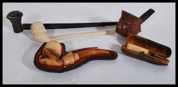 A good groups of vintage pipes to include a carved