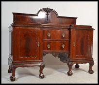 An Edwardian mahogany inverted breakfront Chippend